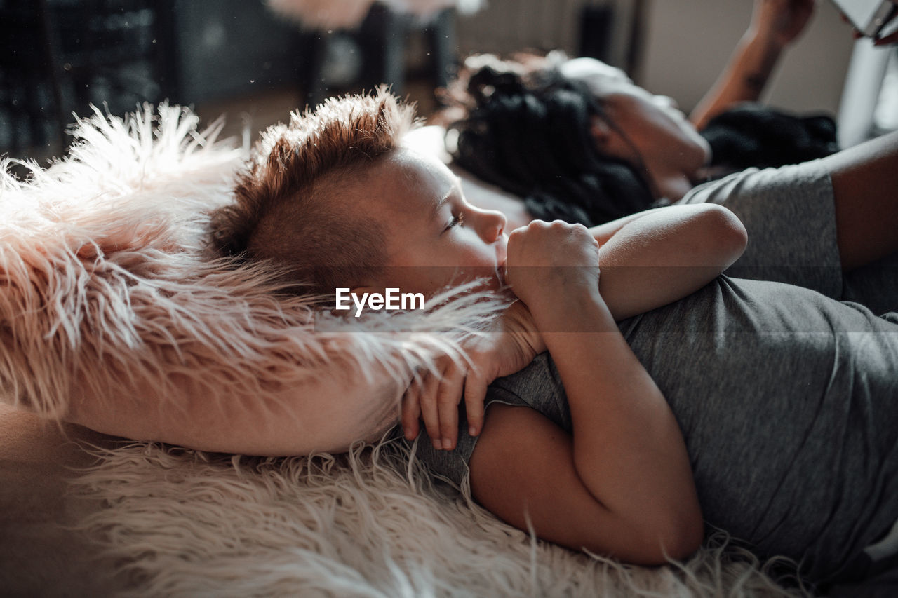 Young woman sleeping on bed at home