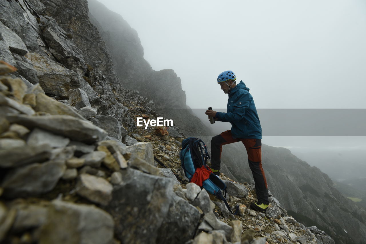 Man standing on rock in mountains