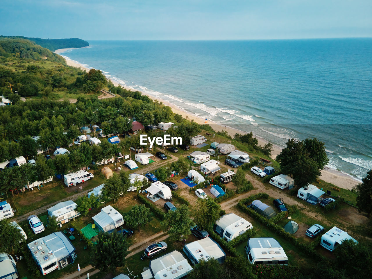 High angle view of tent townscape by sea against sky