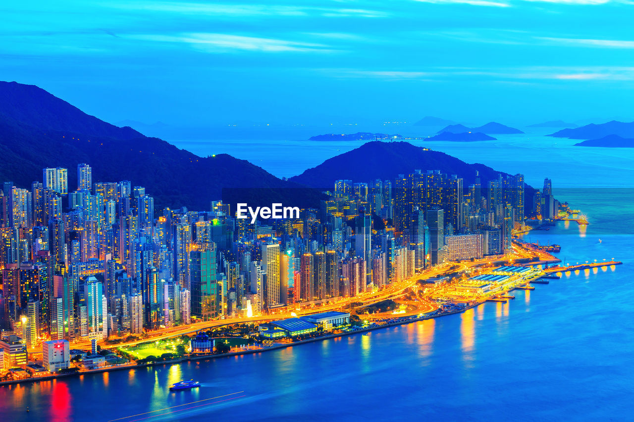 Illuminated city at waterfront