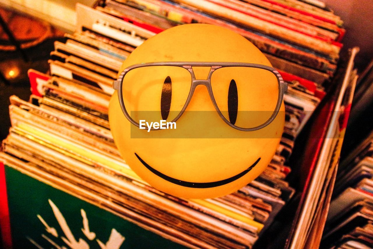High angle view of smiley face with eyeglasses at home