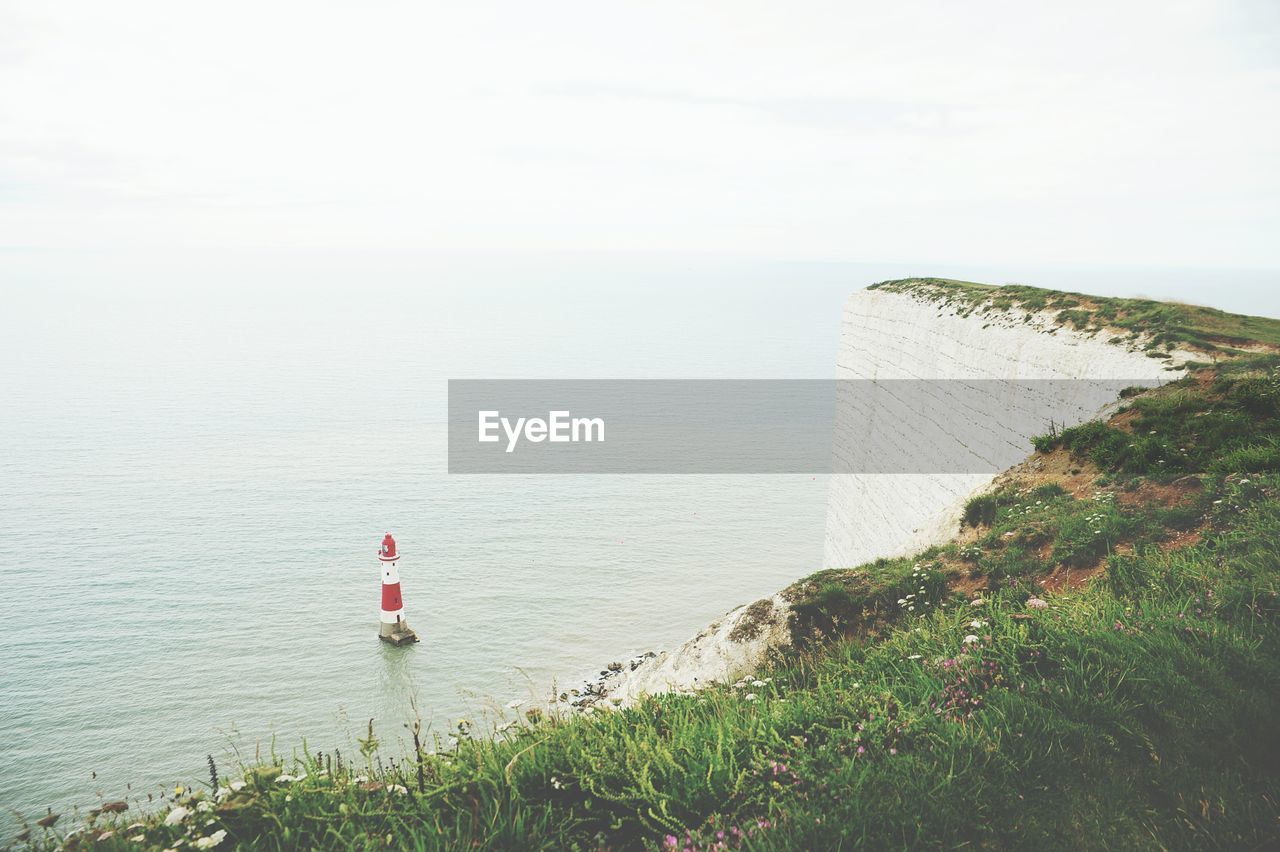 High angle view of cliff by river against sky