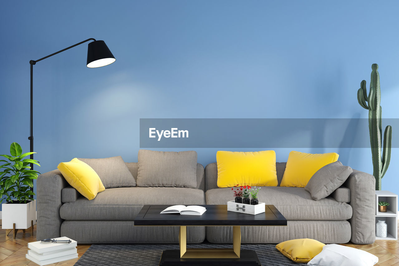 EMPTY SEATS ON SOFA AGAINST WALL AT HOME