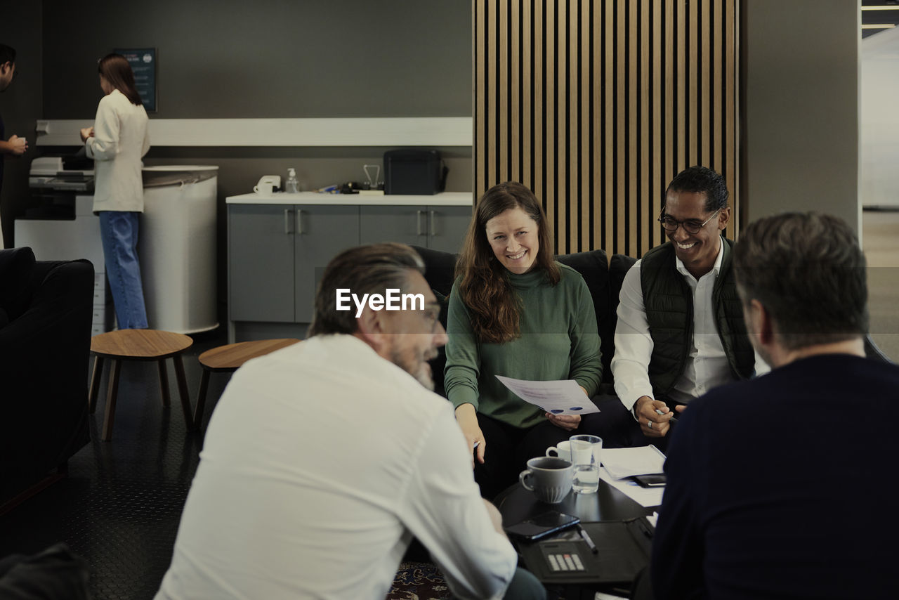 Group of business people having meeting in lobby