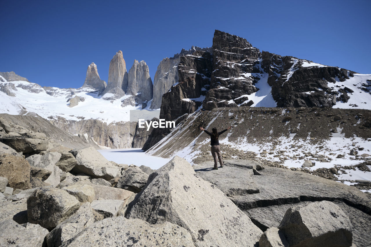 SNOW COVERED ROCKS AGAINST CLEAR SKY
