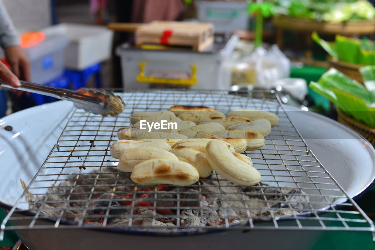 Cooking close-up of grilled banana on the charcoal stove