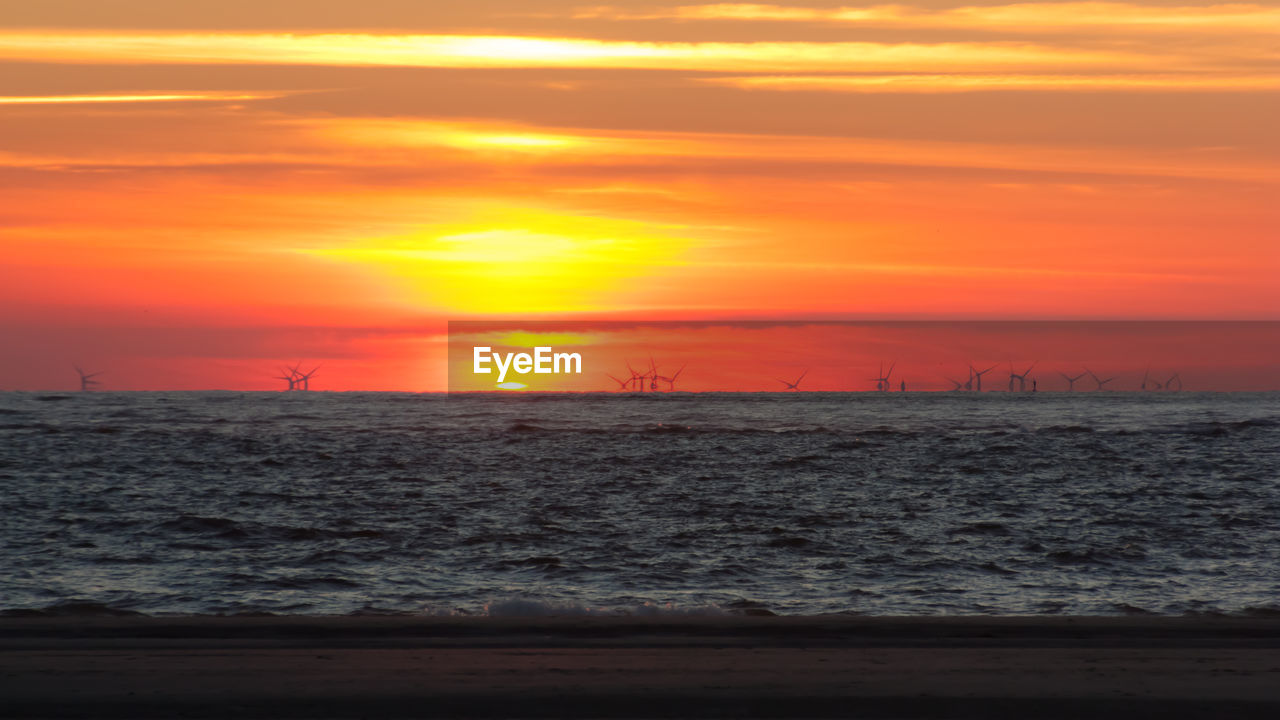 SCENIC VIEW OF SUNSET OVER SEA