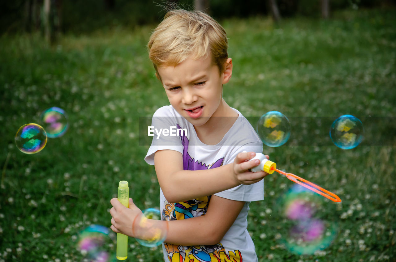 Boy playing with bubbles