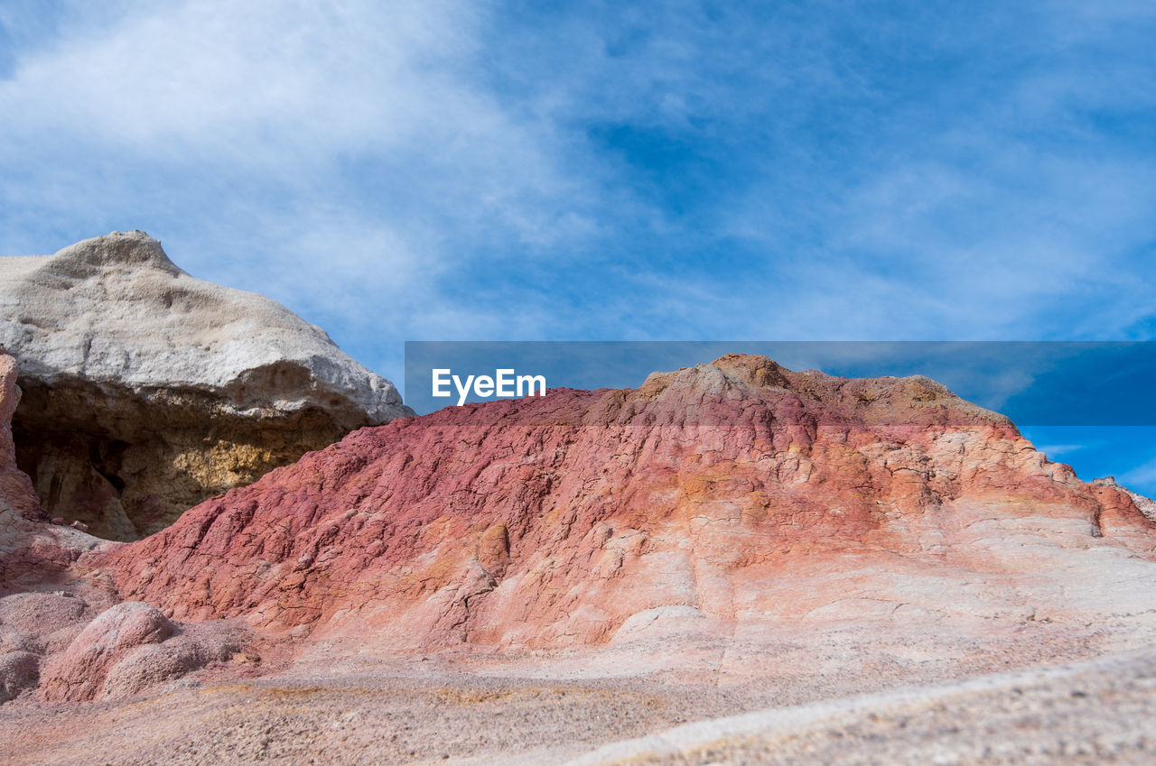 Landscape of pink, orange and white rock formations at interpretive paint mines in colorado