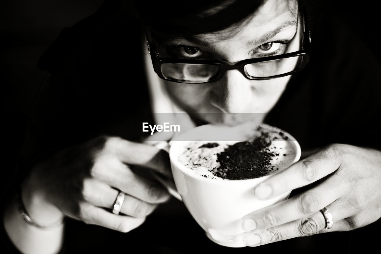 Close-up of woman having drink