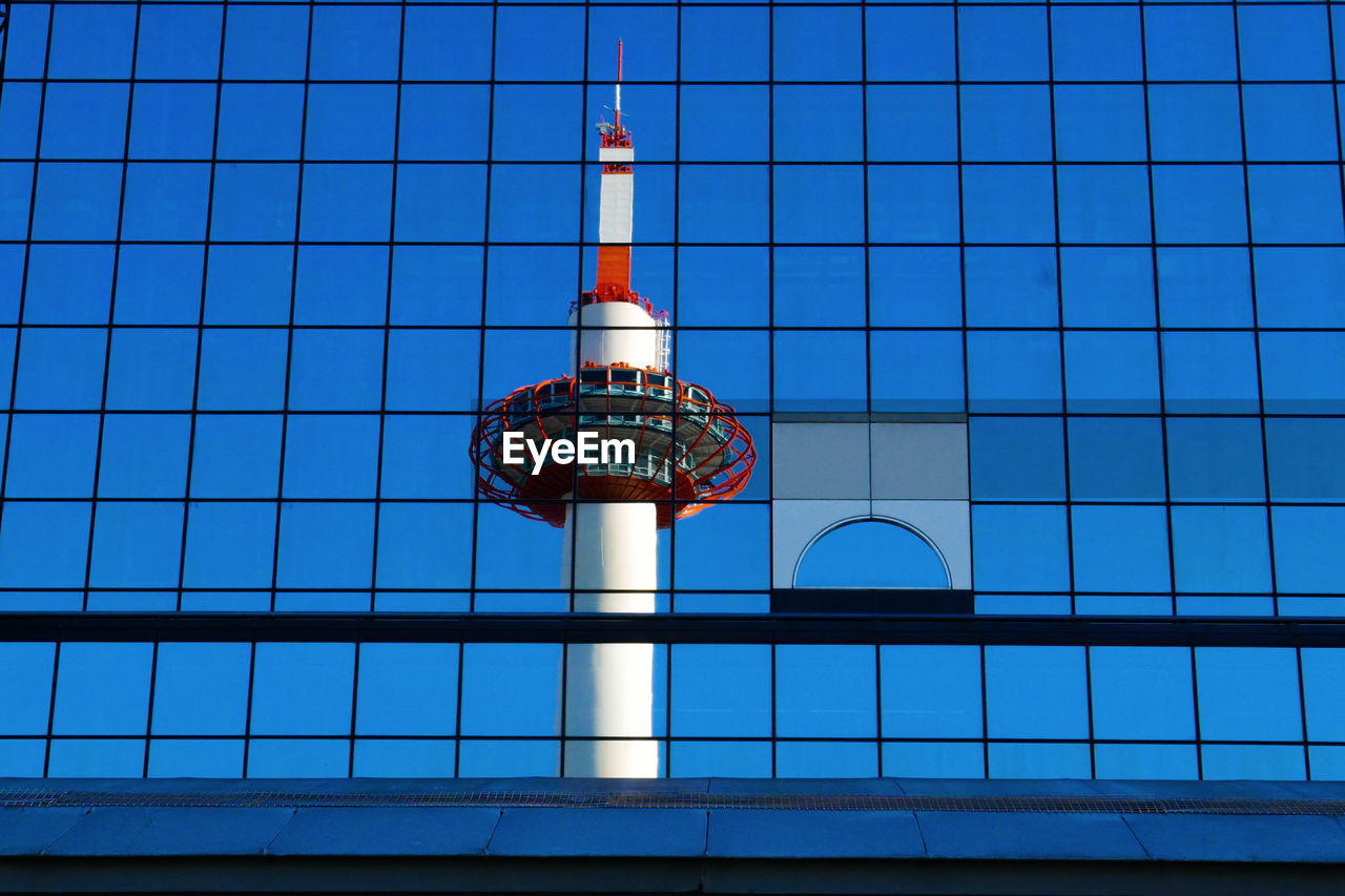 Low angle view of modern building against blue sky