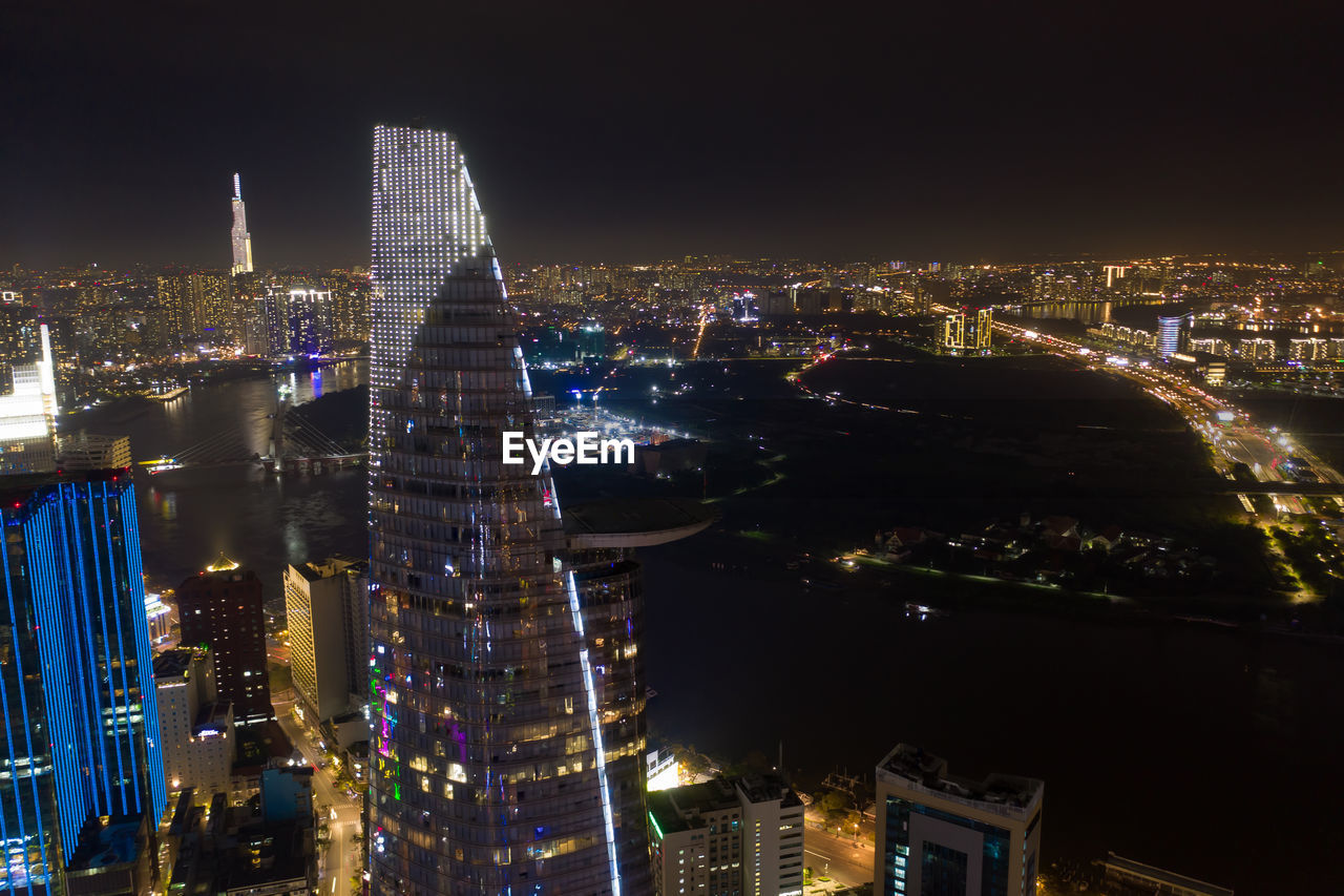 ILLUMINATED BUILDINGS AGAINST SKY AT NIGHT