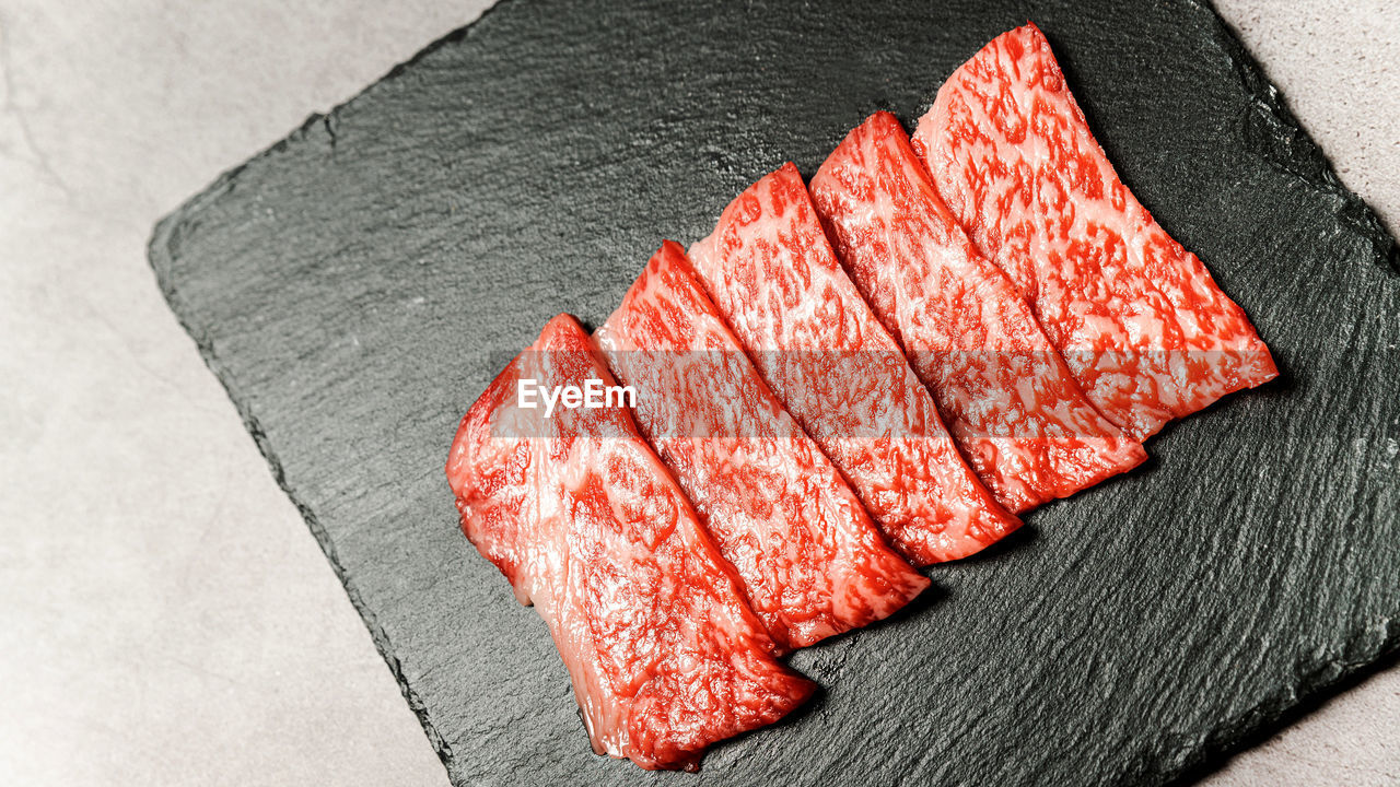 red, food, no people, red meat, high angle view, indoors, close-up, meat, freshness, food and drink, still life, kobe beef, beef