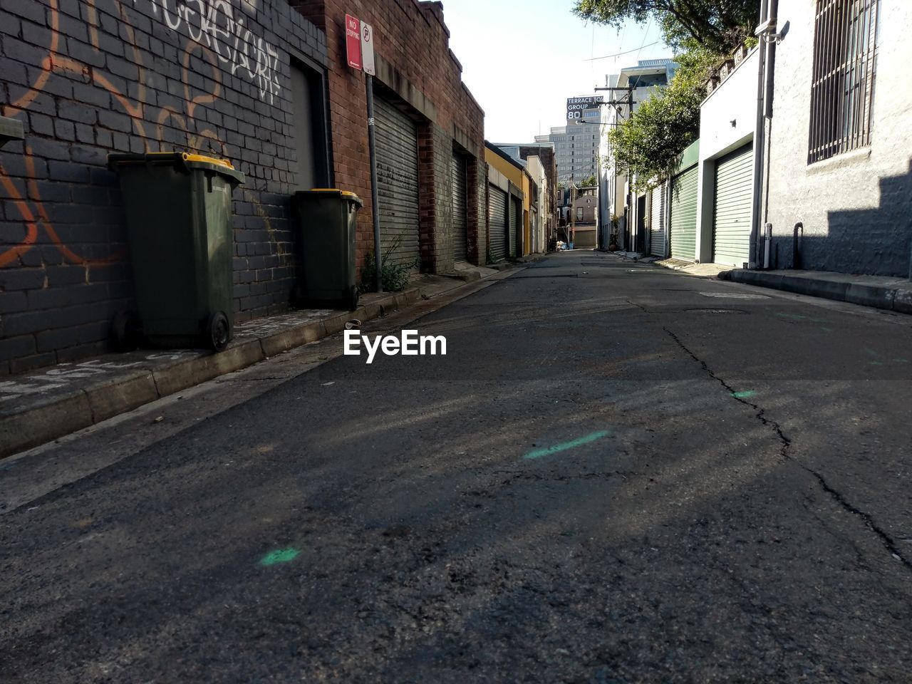 EMPTY STREET AMIDST BUILDINGS IN CITY