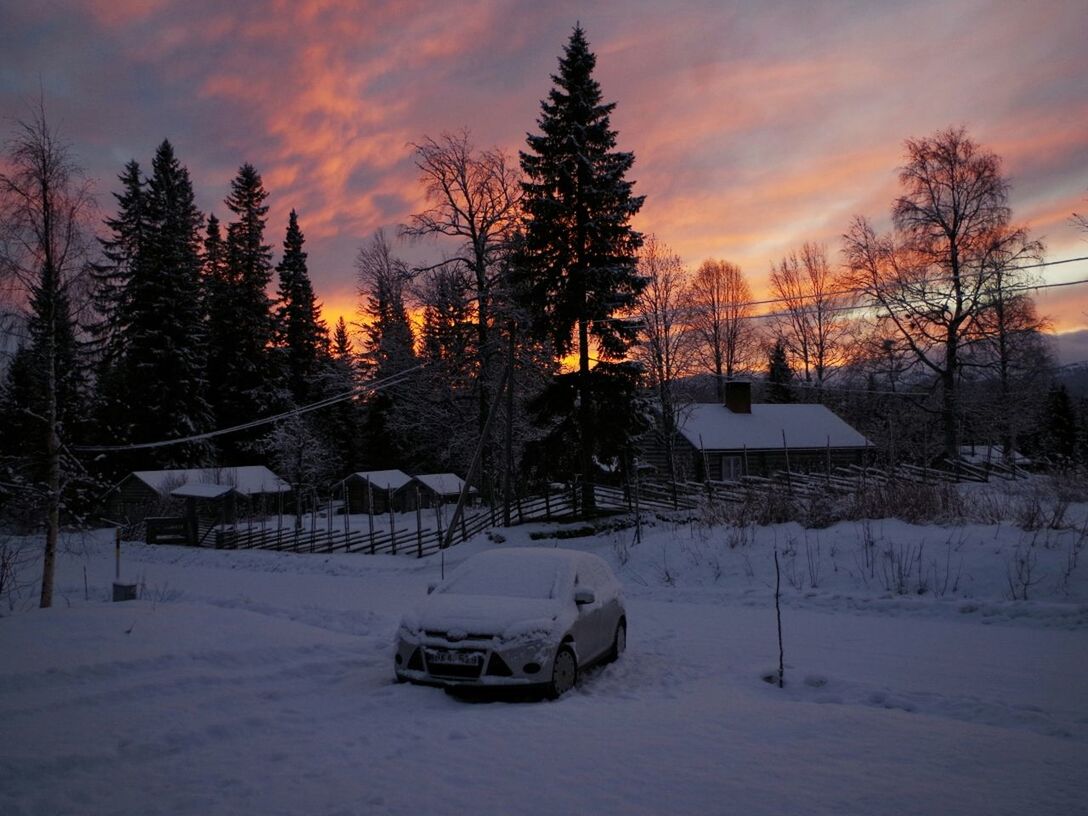 SNOW COVERED LANDSCAPE AT SUNSET