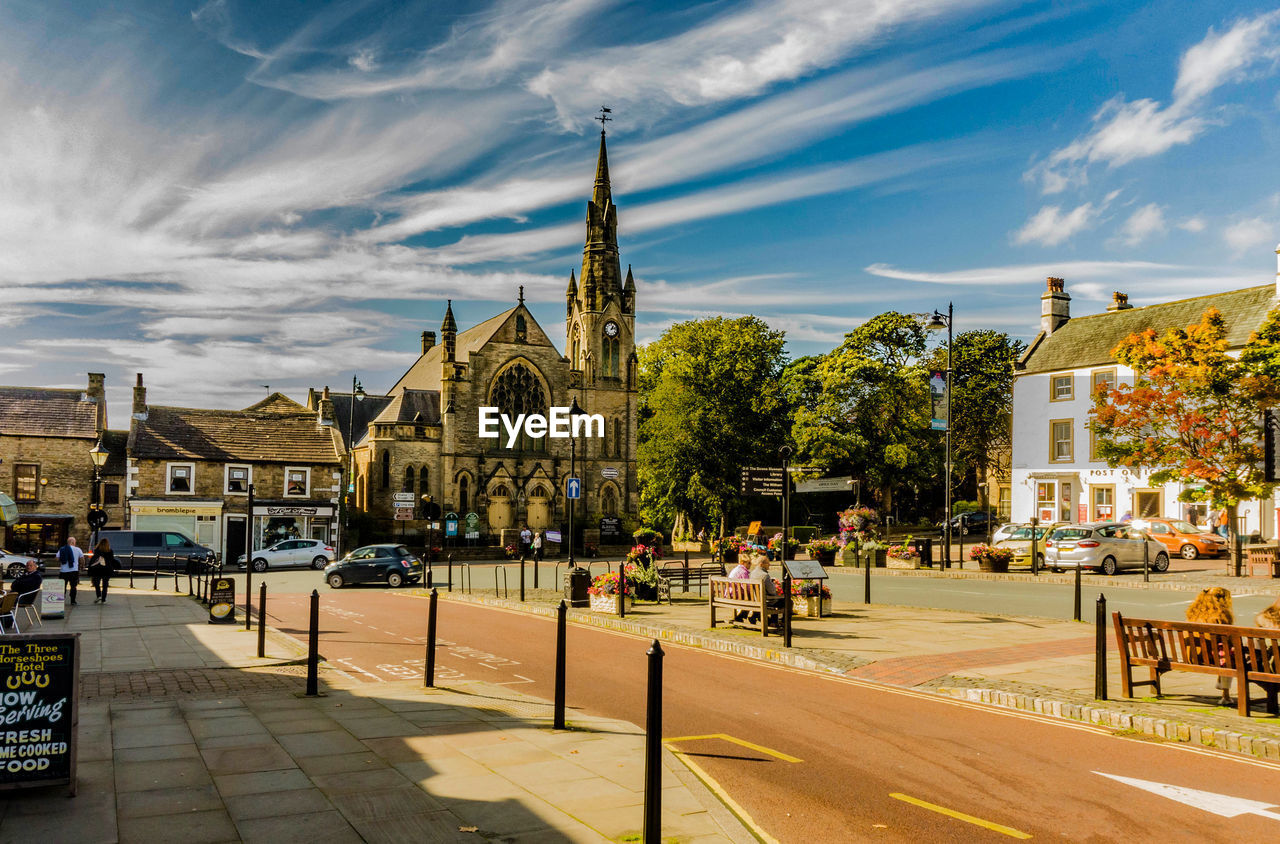 PANORAMIC VIEW OF STREET AND BUILDINGS AGAINST SKY