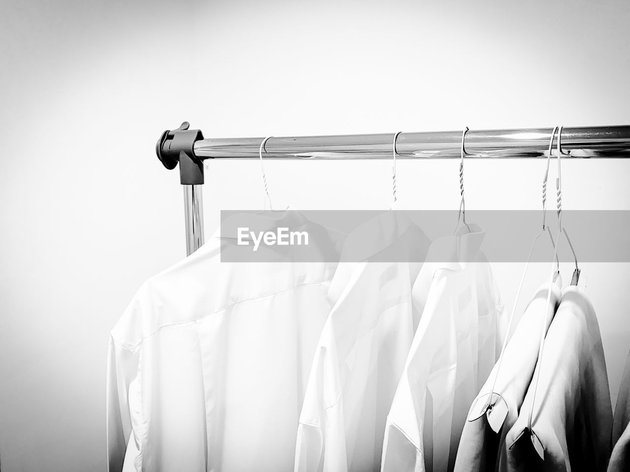 CLOSE-UP OF CLOTHES HANGING ON RACK