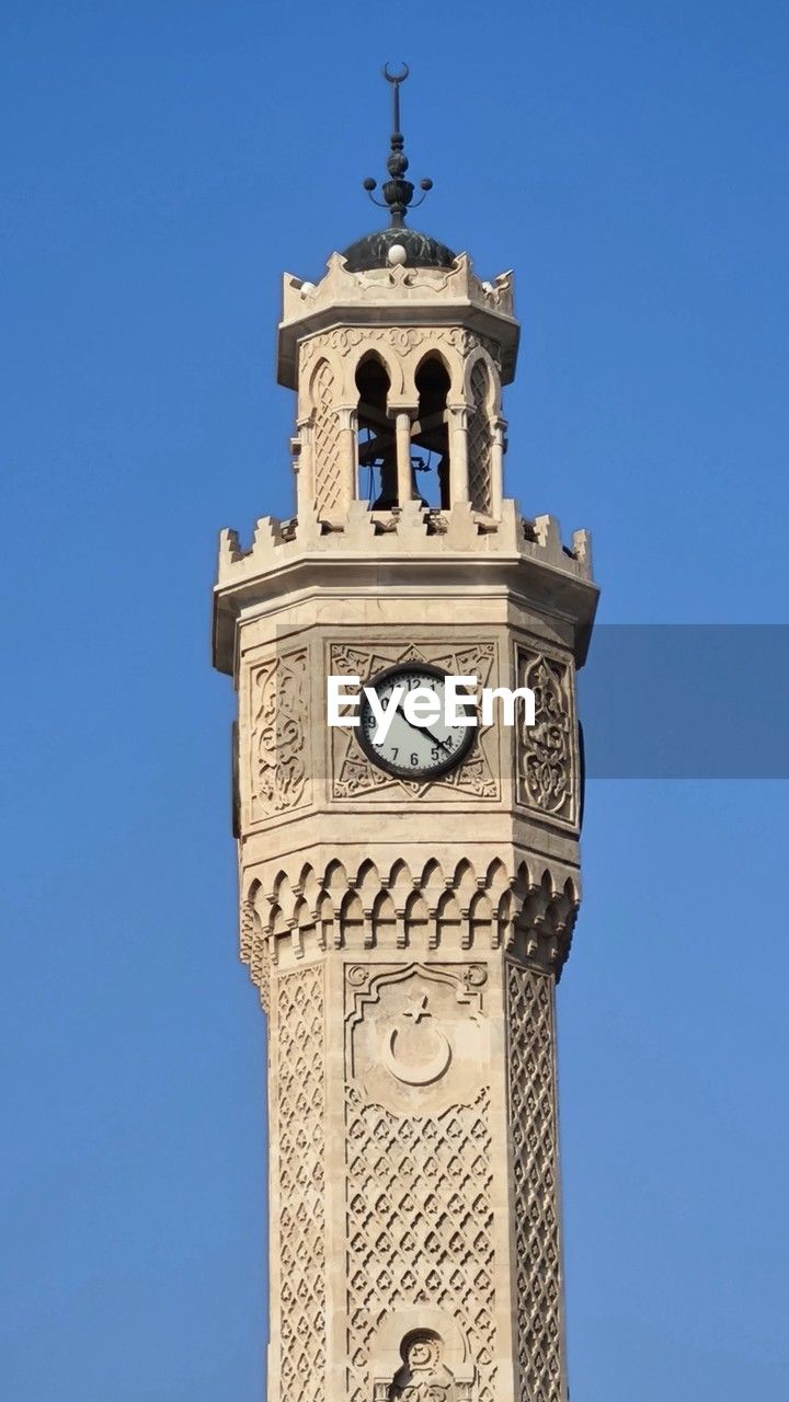 architecture, tower, bell tower, built structure, blue, clock tower, clock, building exterior, sky, time, clear sky, travel destinations, building, steeple, low angle view, nature, history, no people, sunny, the past, day, landmark, travel, clock face, city, outdoors, spire, tourism, religion, place of worship