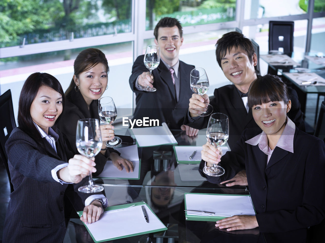 Smiling colleagues with drinks at restaurant during meeting