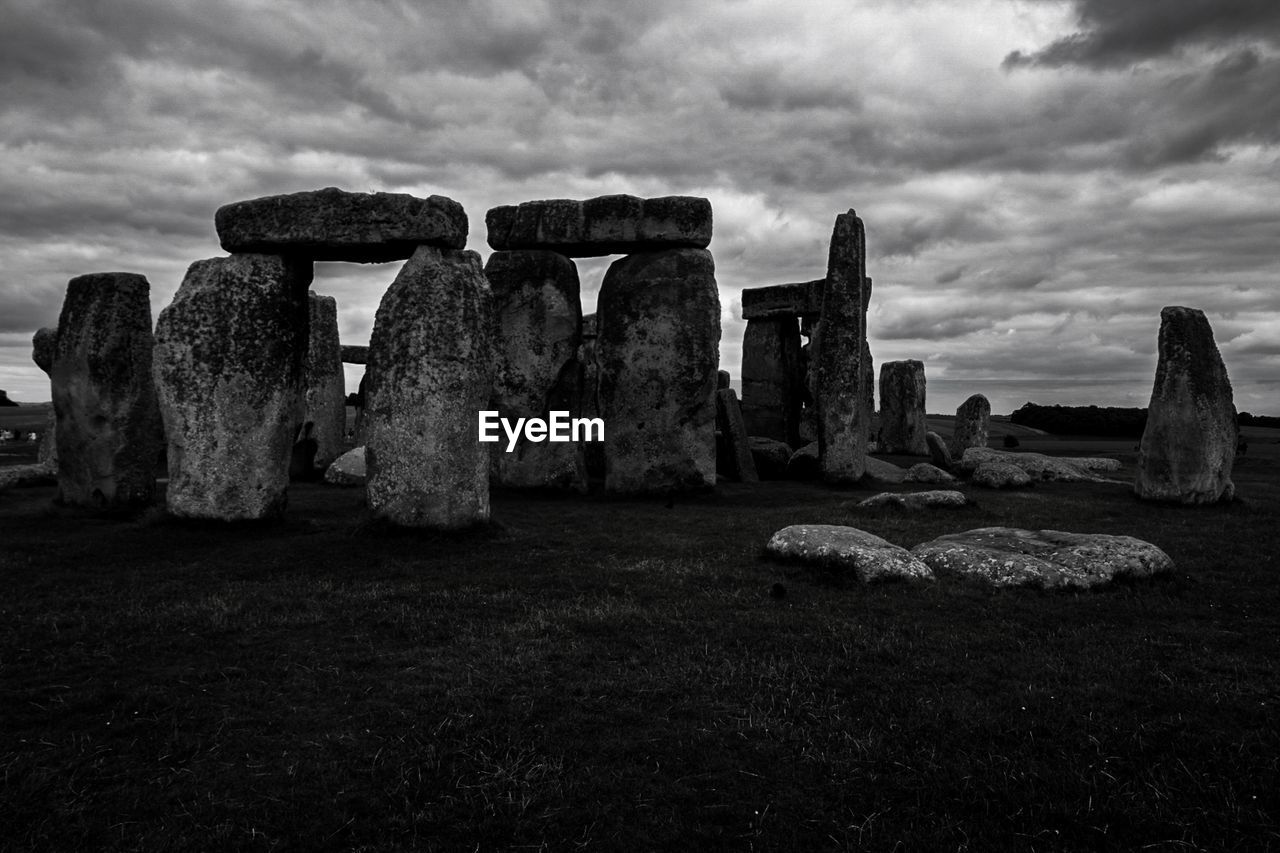 Rock formations on field against sky