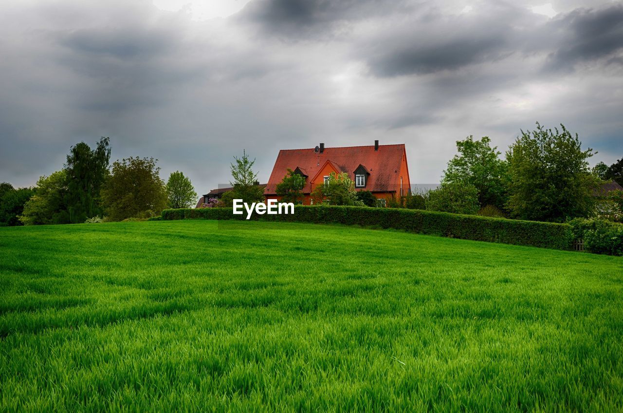 Built structure on field against sky