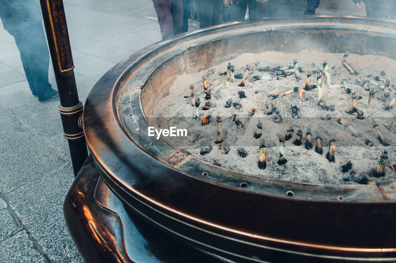 HIGH ANGLE VIEW OF PERSON PREPARING FOOD ON STREET