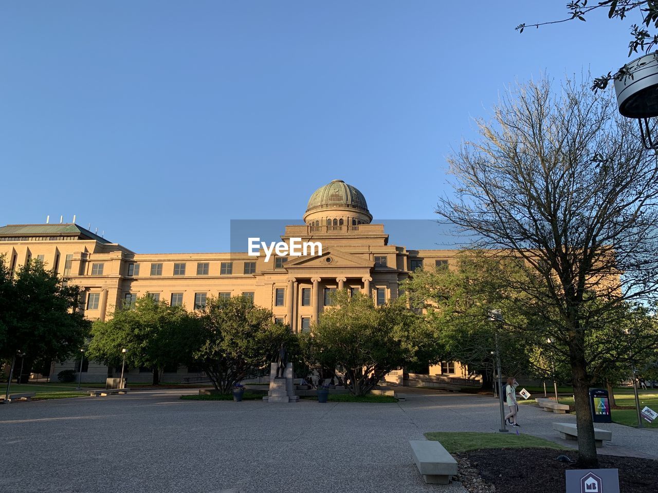 VIEW OF BUILDINGS AND TREES AGAINST BLUE SKY