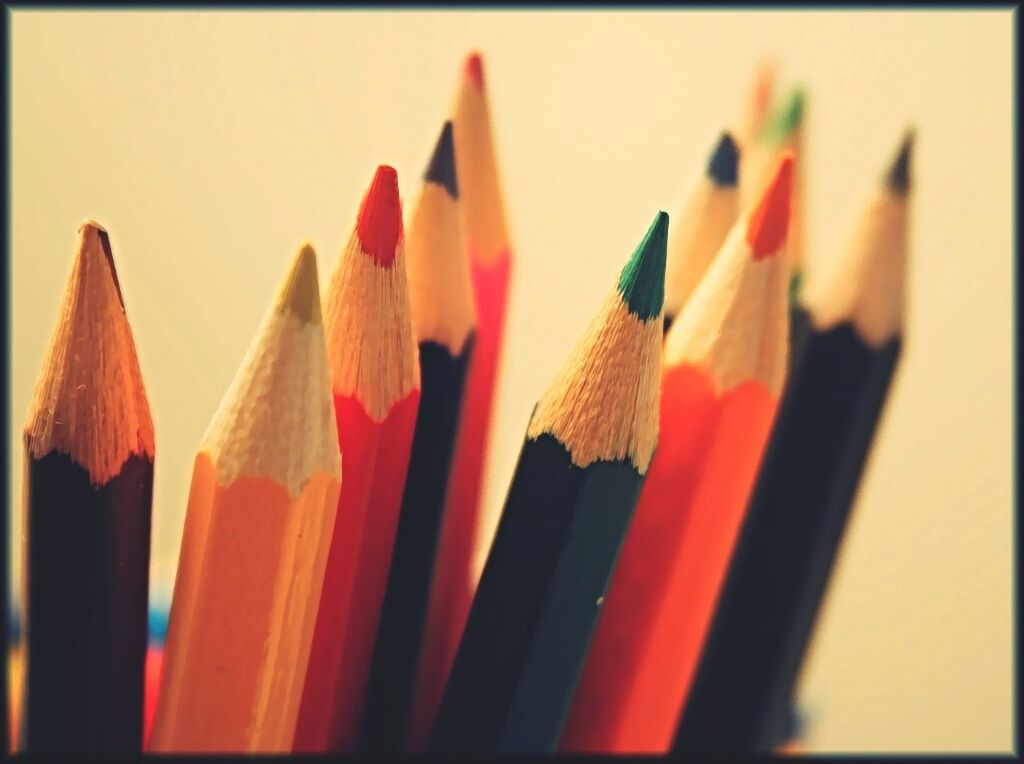 CLOSE-UP OF MULTI COLORED PENCILS ON TABLE