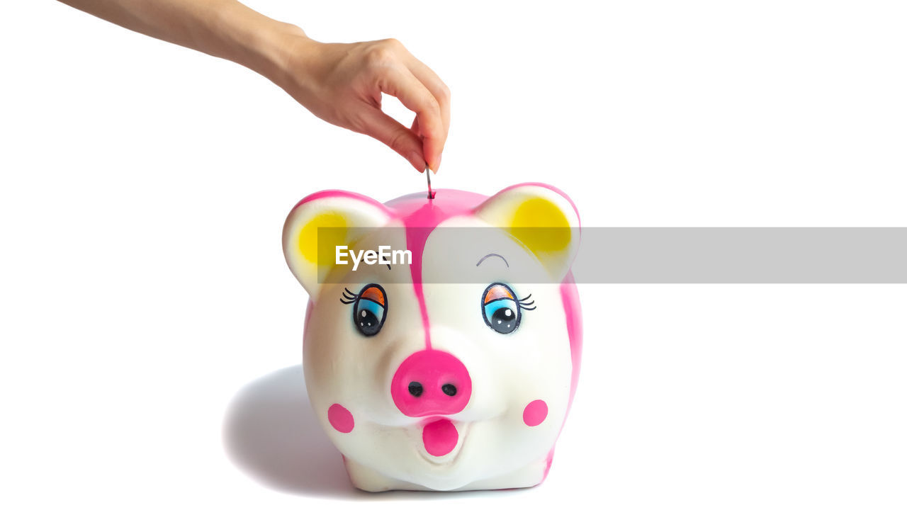 CLOSE-UP OF HAND AGAINST PINK BACKGROUND