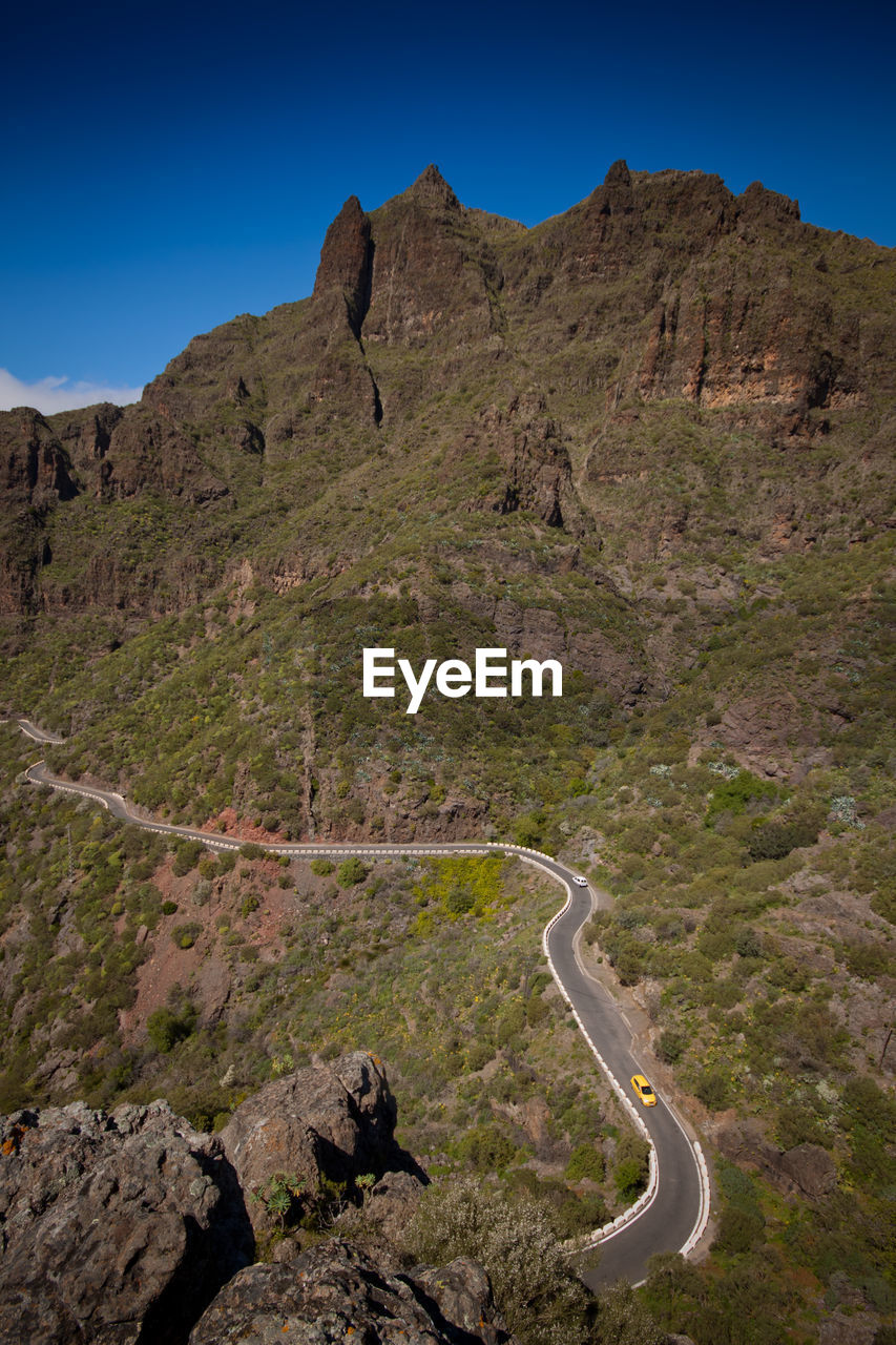 Scenic view of mountains against clear blue sky