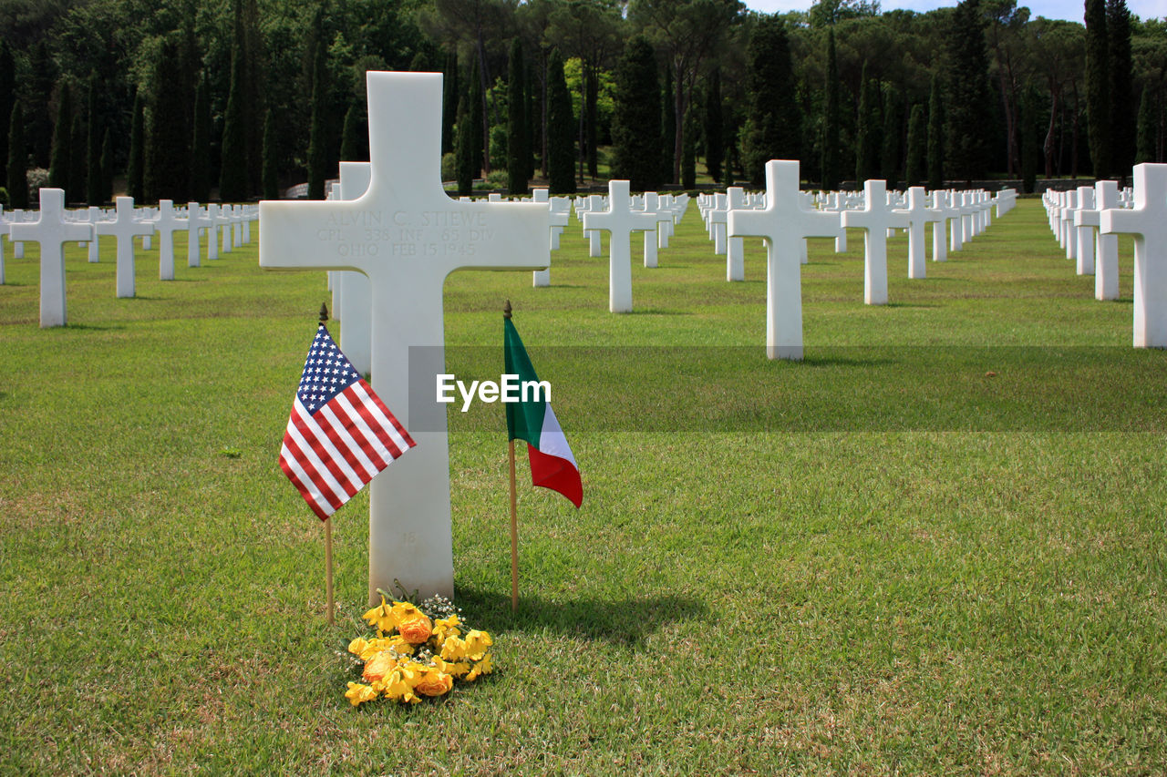 Crosses in green field memorial cemetery of american soldiers died in the second world war