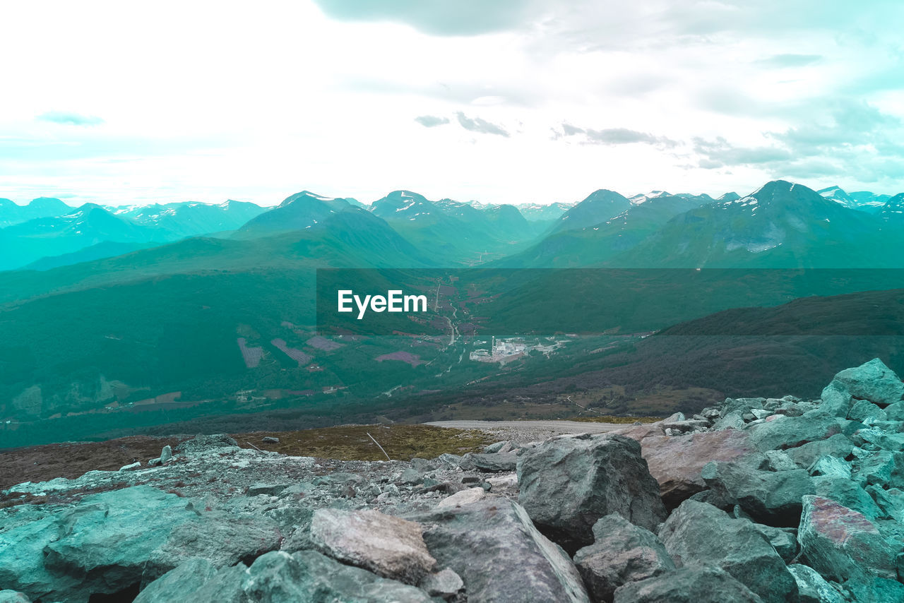 Scenic view of mountains against cloudy sky