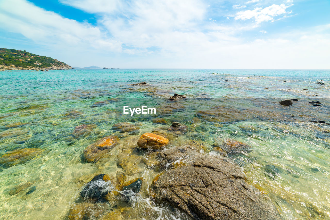 ROCKS IN SEA AGAINST SKY