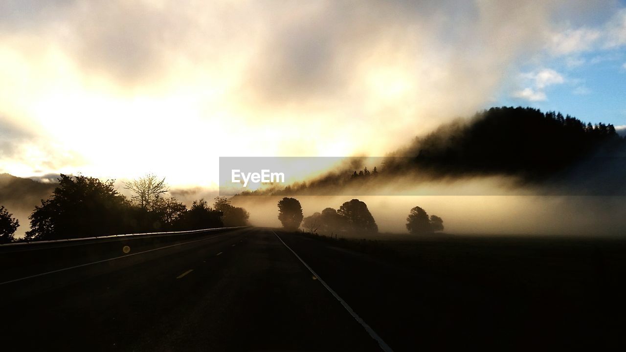 ROAD AGAINST SKY AT SUNSET