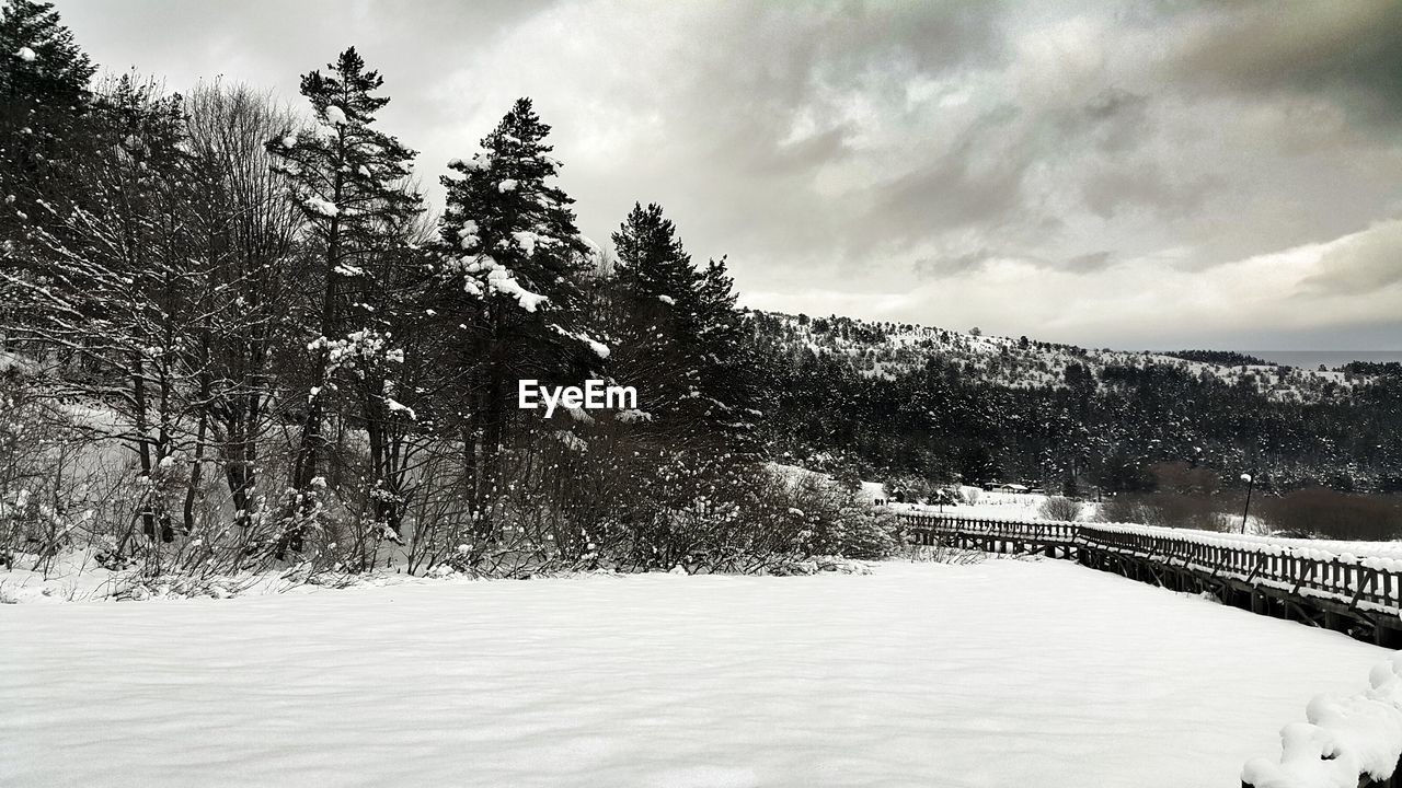 Scenic view of mountains against cloudy sky