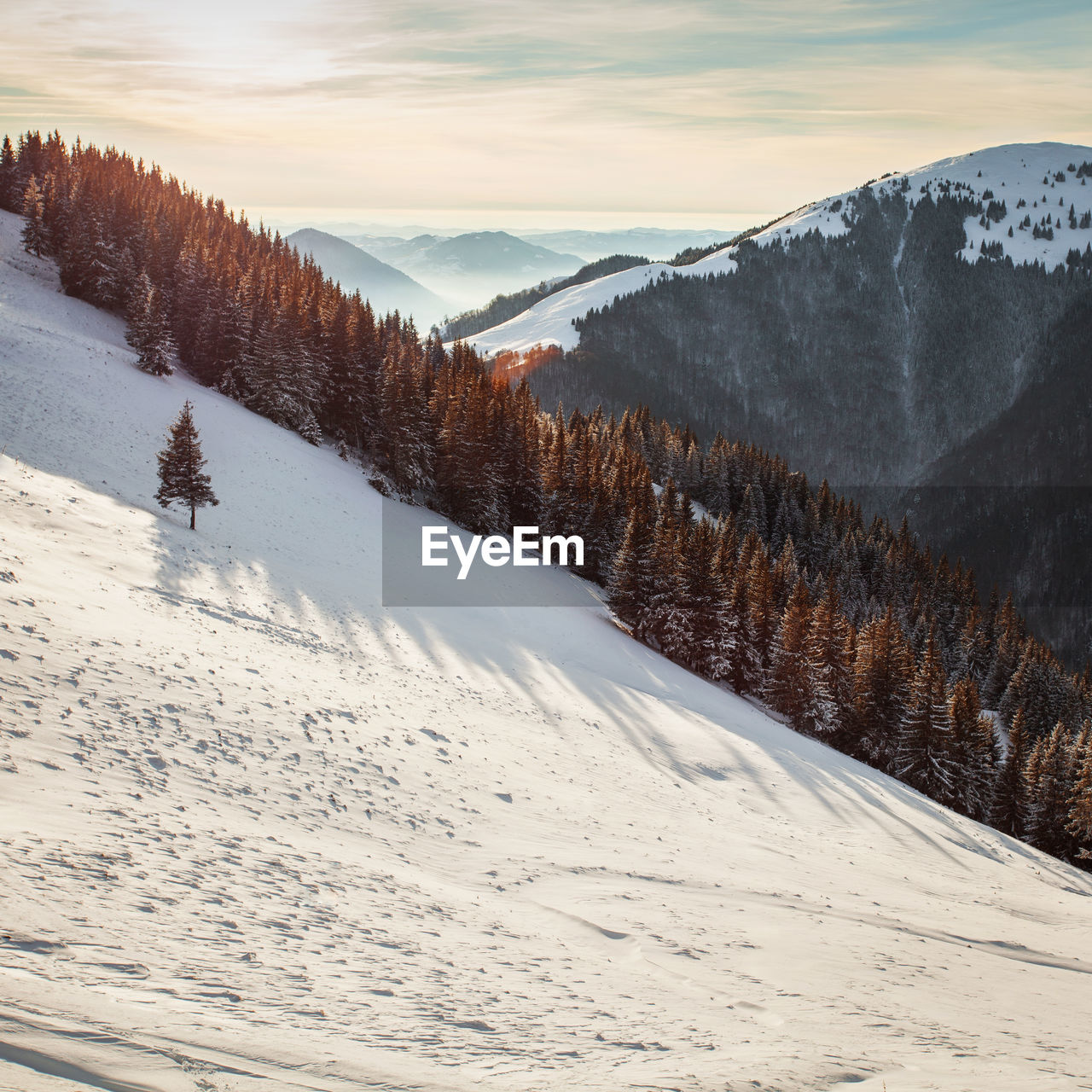 Snow covered landscape against sky