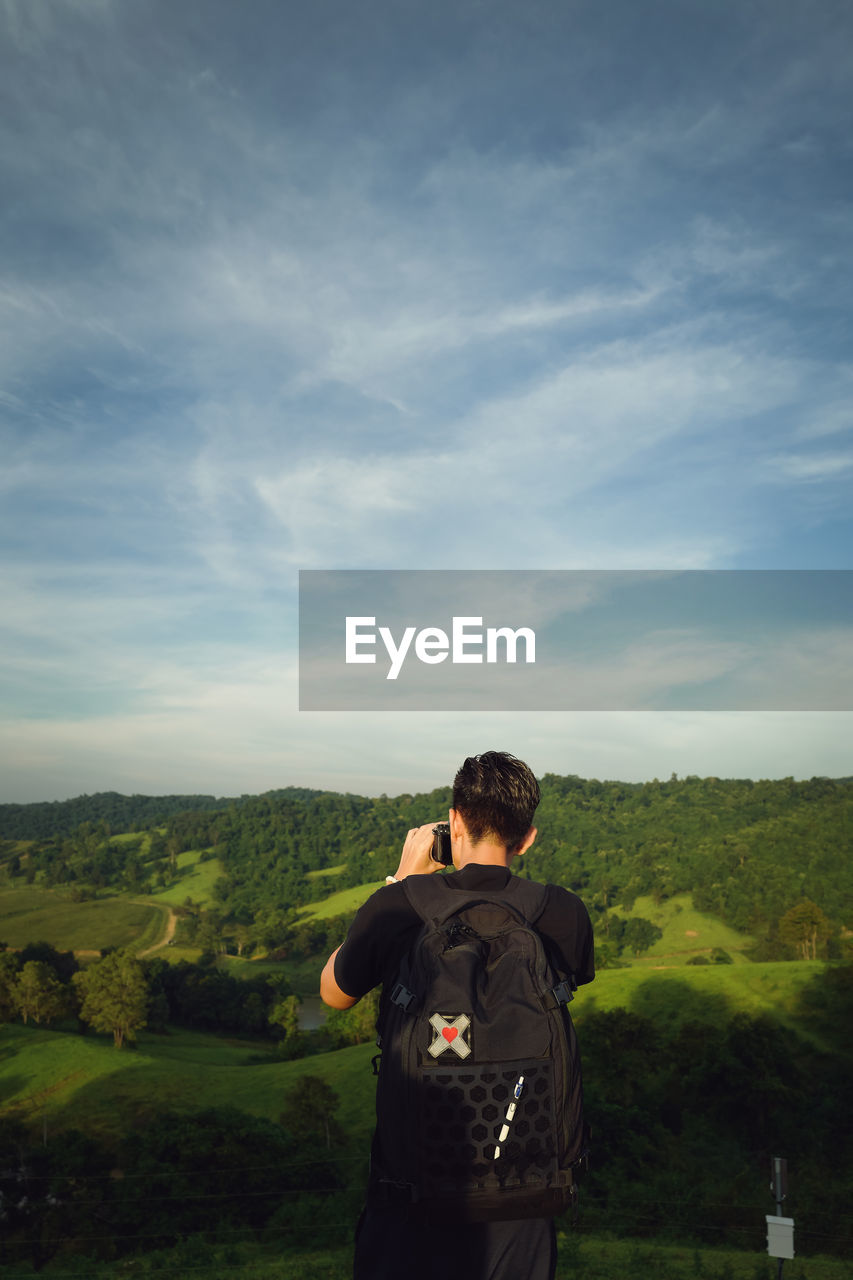 Young man traveller take a shot of nature ,beautiful green evironment