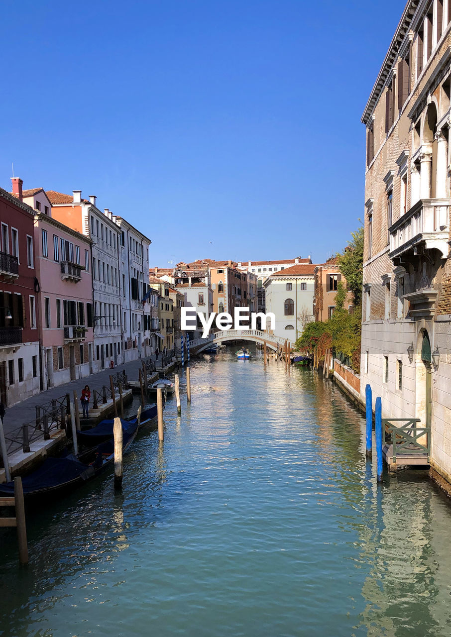 Venetian canal and old brick houses in venice, italy