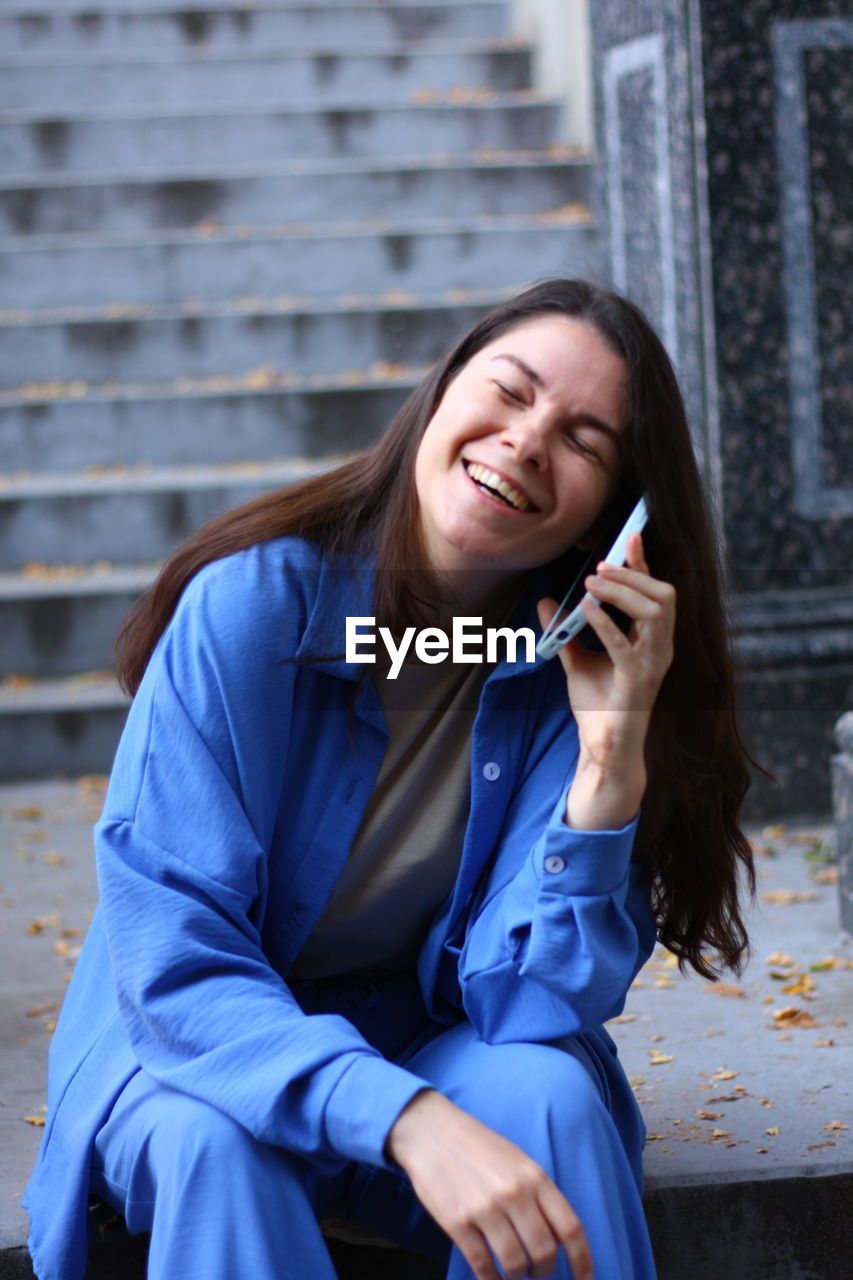 Woman is talking on the phone and laughing