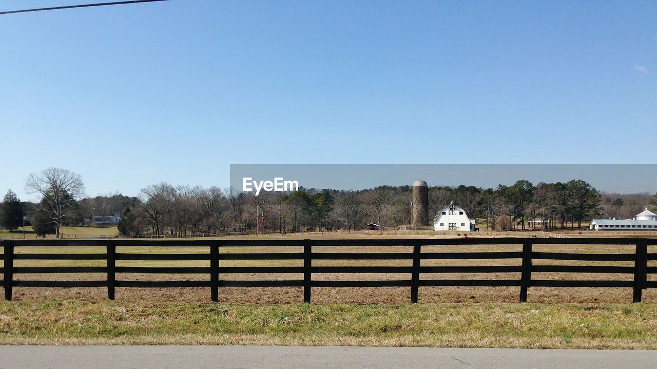 Fence on field against sky