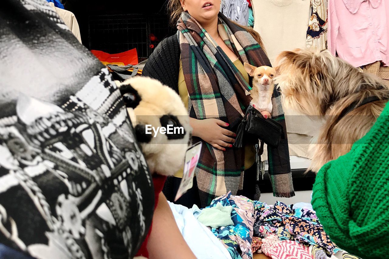 CLOSE-UP OF WOMAN WITH DOG ON STREET