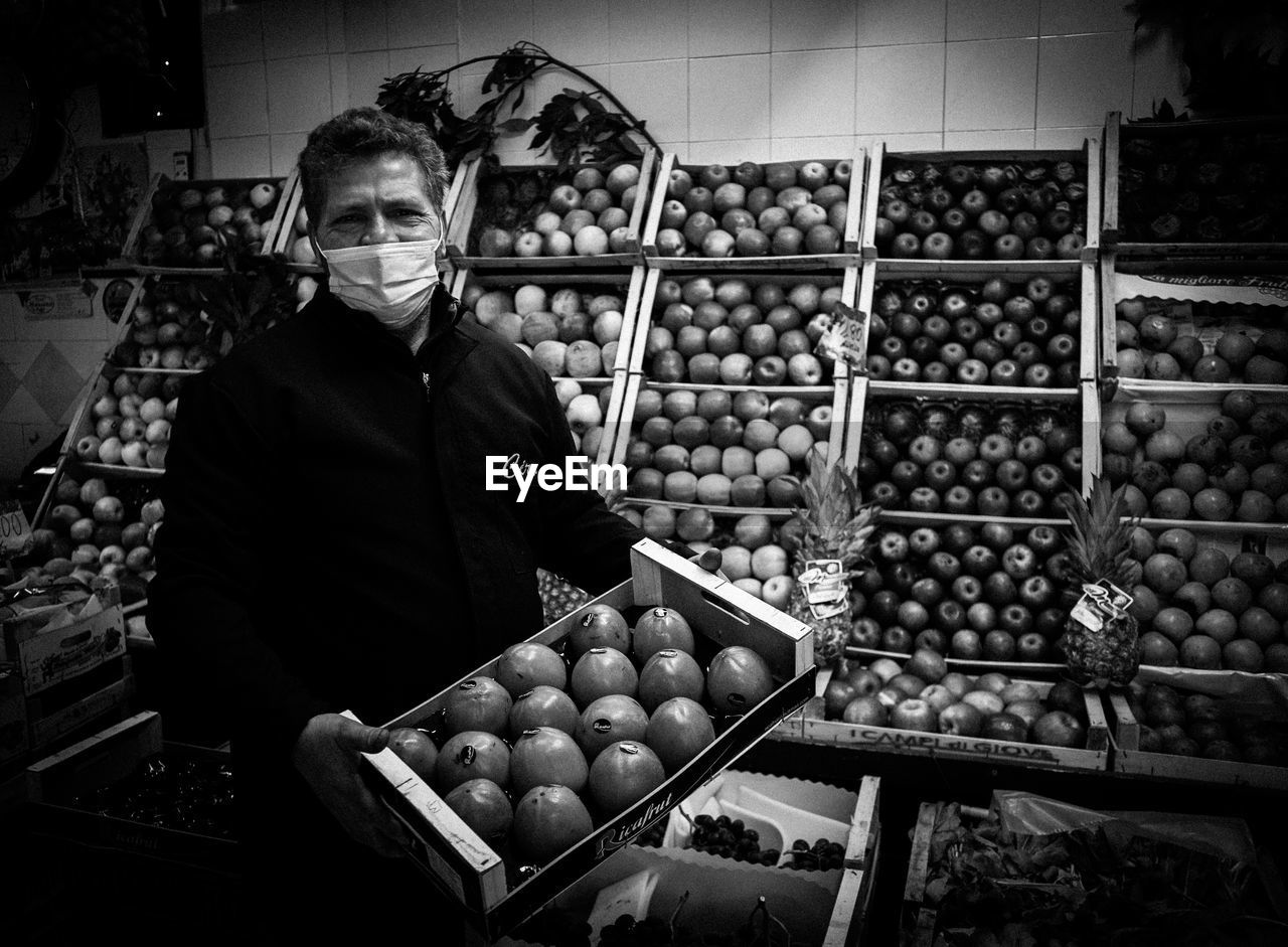 MAN STANDING IN MARKET