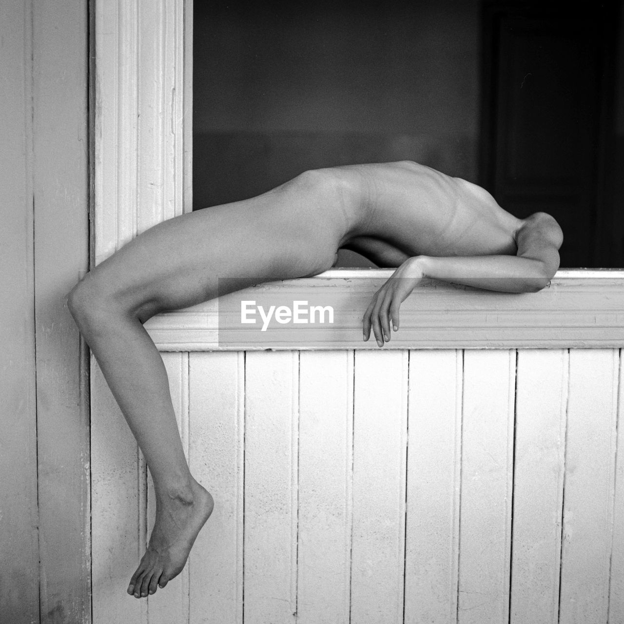 Low section of woman sitting on wooden floor