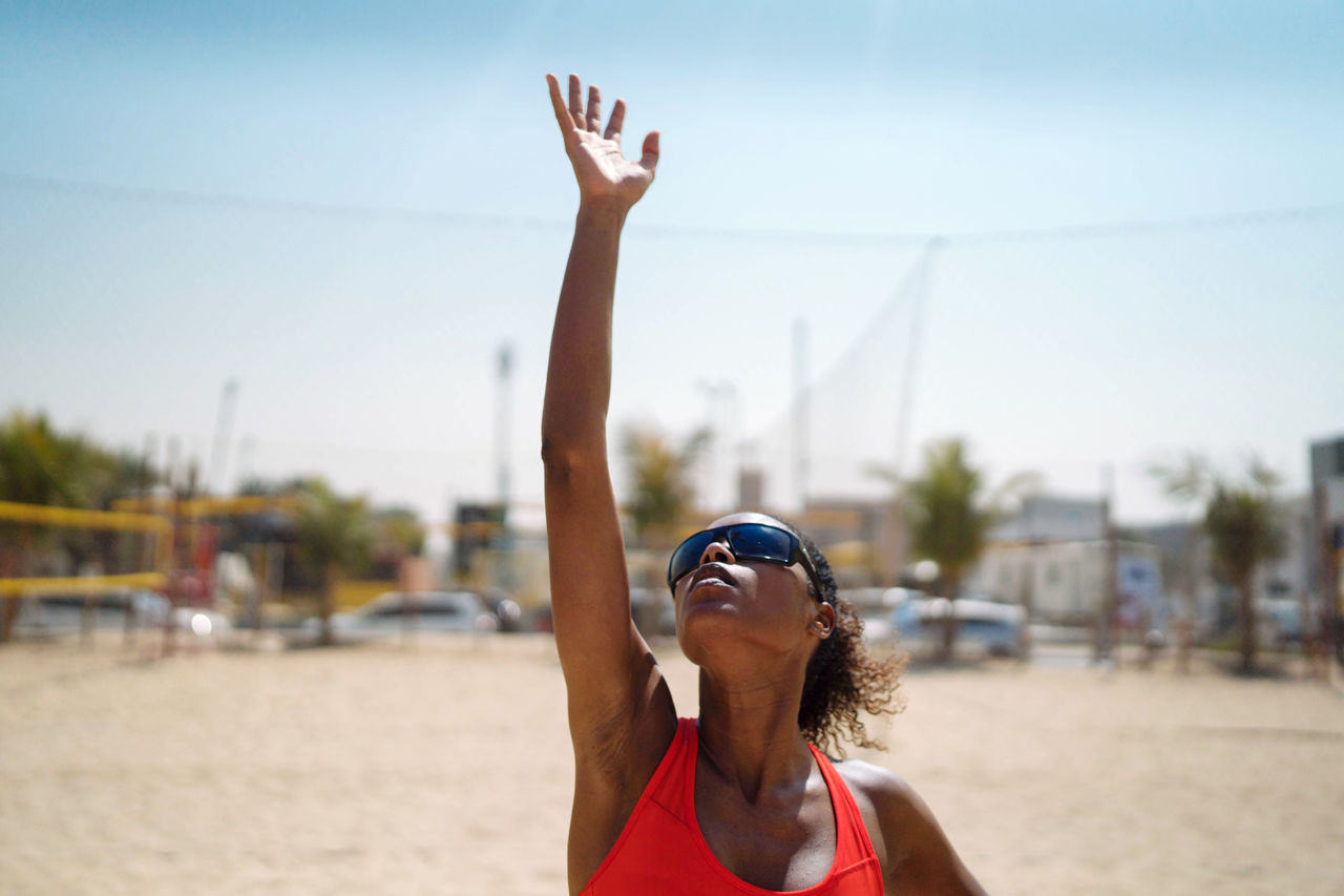 Woman with afro hair playing beach volleyball