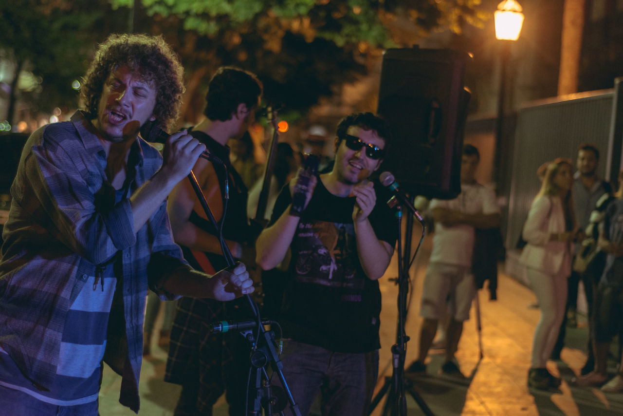 PEOPLE ENJOYING AT CONCERT