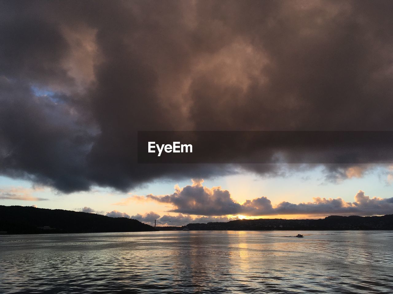 Scenic view of dramatic sky over lake