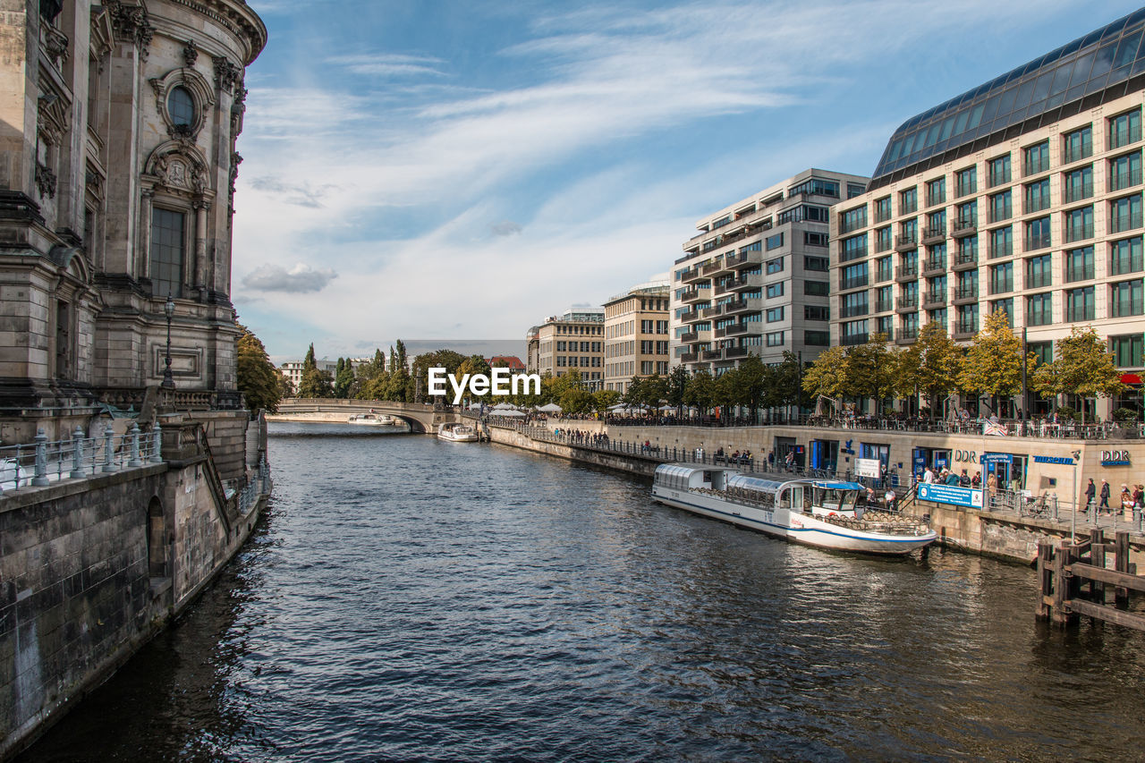 View of river in city against sky