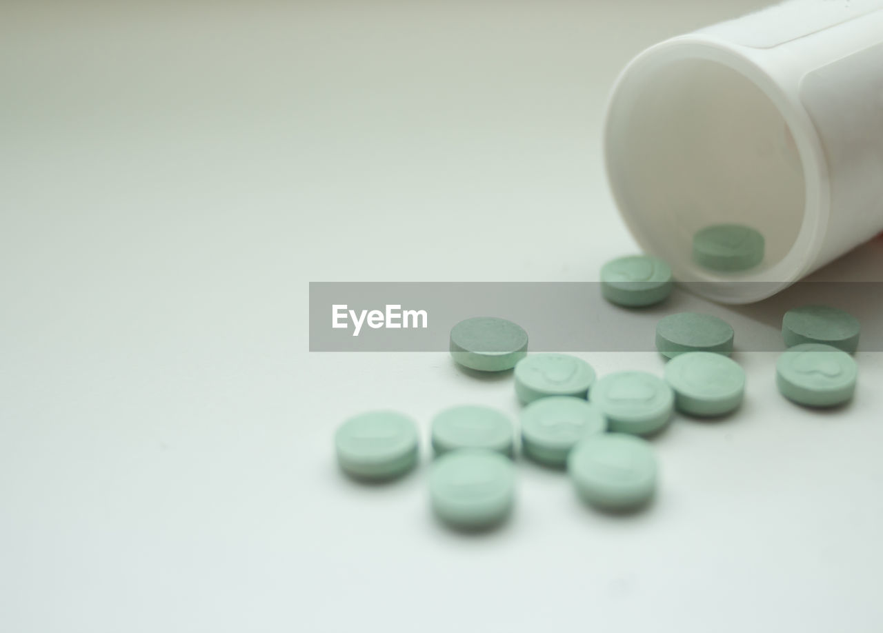 Close-up of pills over white background