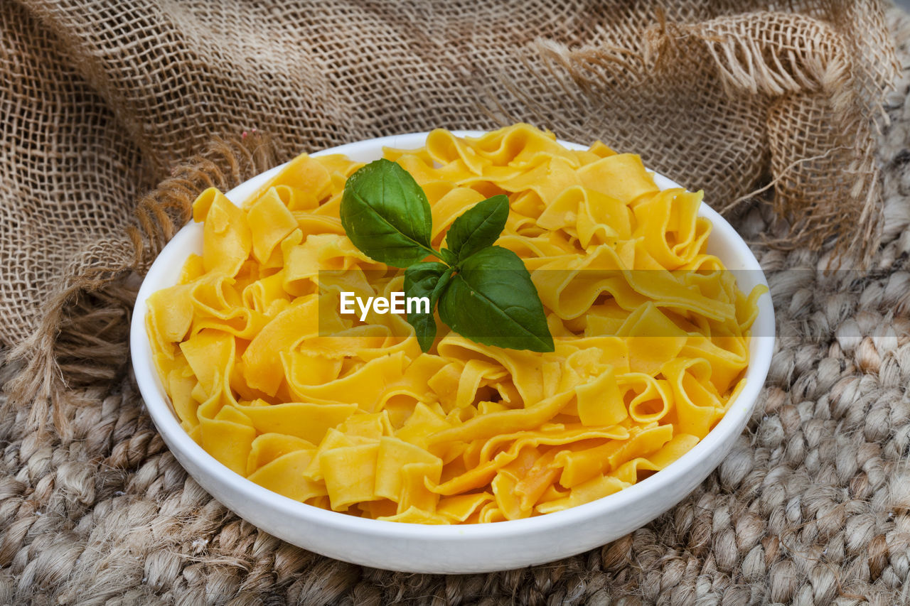 Bowl of cooked plain butternut pasta on rustic table