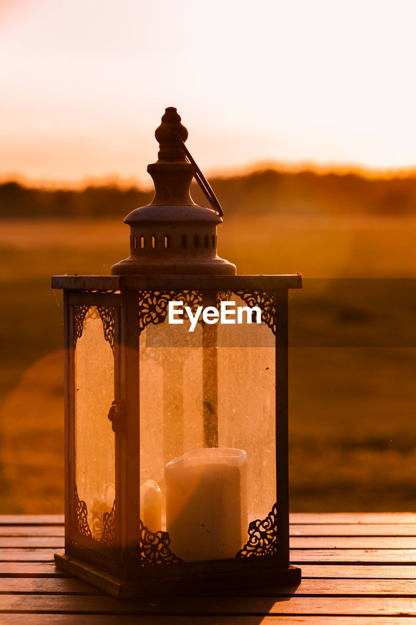 Vintage candle light on a table in romantic summer evening light